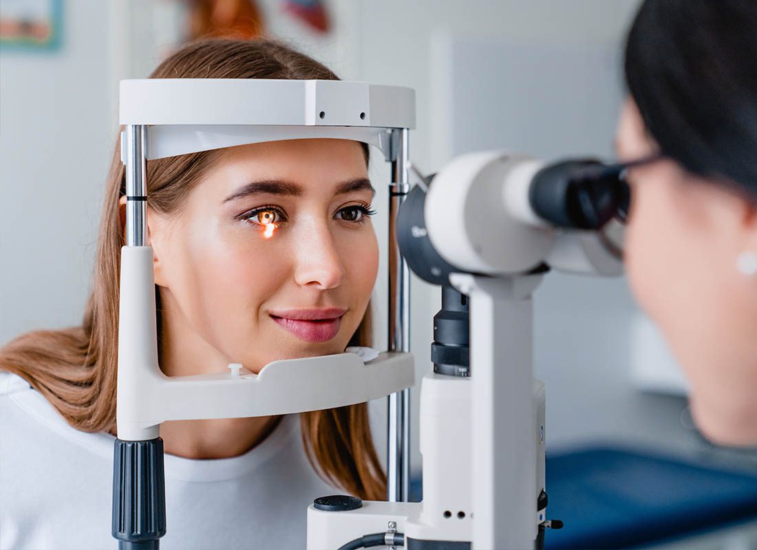 Group Vision Insurance - Woman Getting an XRay of Her Eye During an Eye Exam